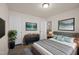A beautifully staged bedroom features modern furnishings and artwork at 232 Kanewind Ter, Apex, NC 27523