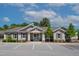 Well-maintained clubhouse exterior with ample parking and lovely landscaping on a sunny day at 232 Kanewind Ter, Apex, NC 27523