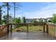 View of the wood deck with a wood rail fence that overlooks the grass lawn at 232 Kanewind Ter, Apex, NC 27523