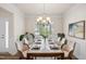 Elegant dining room featuring stylish chairs, a marble-top table, and a contemporary painting at 232 Kanewind Ter, Apex, NC 27523