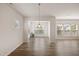 Bright dining room with wood floors, modern lighting, and neutral walls at 232 Kanewind Ter, Apex, NC 27523