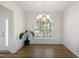 Bright dining area featuring hardwood floors, elegant chandelier, and wainscoting at 232 Kanewind Ter, Apex, NC 27523