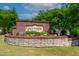 Community entrance sign, showcasing the beautiful landscaping and brickwork in a natural, green setting at 232 Kanewind Ter, Apex, NC 27523