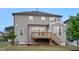 Back exterior view of home, features a deck with stairs and gray siding at 232 Kanewind Ter, Apex, NC 27523