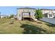 Exterior back view of home with a walkout wood deck and green grass at 232 Kanewind Ter, Apex, NC 27523
