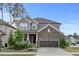 Charming two-story home featuring stone accents, gray siding, and a two-car garage at 232 Kanewind Ter, Apex, NC 27523