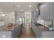 Modern kitchen features granite countertops, stainless steel appliances, and gray cabinets at 232 Kanewind Ter, Apex, NC 27523