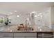 Kitchen island with stainless steel sink, granite counters and views into living room at 232 Kanewind Ter, Apex, NC 27523