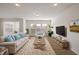 Staged living room with large windows and furniture at 232 Kanewind Ter, Apex, NC 27523