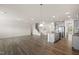 Open-concept living space with wood floors and a staircase at 232 Kanewind Ter, Apex, NC 27523