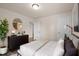 A beautifully staged main bedroom features an accent wall and modern furniture at 232 Kanewind Ter, Apex, NC 27523