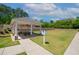 Community pavilion featuring a picnic table, fans, and lush green landscaping at 232 Kanewind Ter, Apex, NC 27523