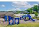 Brightly colored playground equipment on a soft bed surface with nearby community building at 232 Kanewind Ter, Apex, NC 27523