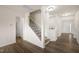 Staircase with wood floors and black wrought iron at 232 Kanewind Ter, Apex, NC 27523