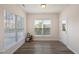 Bright sunroom with ample natural light and wood floors at 232 Kanewind Ter, Apex, NC 27523