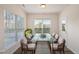 Bright sunroom with a glass table and seating for six at 232 Kanewind Ter, Apex, NC 27523