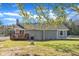 View of the backyard featuring a wooden deck and a stone exterior at 2501 Ferrell Rd, Durham, NC 27704