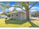 Shot of the backyard showing a beautiful shade tree and cinder block exterior at 2501 Ferrell Rd, Durham, NC 27704