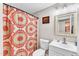 Cozy bathroom with bright accents, vanity, commode and decorative shower curtain at 2501 Ferrell Rd, Durham, NC 27704