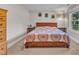 Cozy bedroom features a wood bed frame, neutral paint, and natural light at 2501 Ferrell Rd, Durham, NC 27704