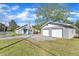 Property includes a home with stone chimney and a two-car garage with white doors on a well-maintained lawn at 2501 Ferrell Rd, Durham, NC 27704