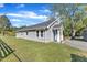 Exterior of home featuring stone facade, front porch, and well-manicured lawn at 2501 Ferrell Rd, Durham, NC 27704