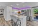 Contemporary kitchen featuring a center island with seating, stainless steel appliances, and under-cabinet lighting at 2501 Ferrell Rd, Durham, NC 27704