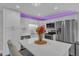 Modern kitchen featuring stainless steel appliances, white cabinets, a breakfast bar, and stylish decor at 2501 Ferrell Rd, Durham, NC 27704
