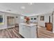 Open living room features a kitchen island, recessed lighting, and LVP flooring throughout at 2501 Ferrell Rd, Durham, NC 27704