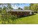 View of the home's rear exterior surrounded by an expansive lawn at 2910 Dove Ln, Raleigh, NC 27604