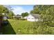 Spacious backyard featuring a detached garage and ample green space at 2910 Dove Ln, Raleigh, NC 27604