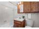 Bathroom featuring tiled walls, wood cabinets and vintage decor at 2910 Dove Ln, Raleigh, NC 27604