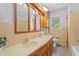 Bathroom featuring double sink vanity, wood cabinets and vintage decor at 2910 Dove Ln, Raleigh, NC 27604
