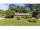 Charming brick home with well-maintained landscaping and a covered parking area at 2910 Dove Ln, Raleigh, NC 27604