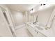 Bathroom featuring dual sinks, a large mirror, and a glass-enclosed shower at 2917 Alyssa Ct, Knightdale, NC 27604