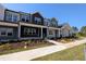 Charming new townhomes feature colorful siding, inviting front porches, and professionally landscaped front yards at 2917 Alyssa Ct, Knightdale, NC 27604