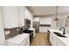 Bright kitchen featuring stainless steel appliances, white cabinets, and tile backsplash at 2917 Alyssa Ct, Knightdale, NC 27604