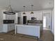 Spacious kitchen featuring white cabinets, stainless steel appliances, island, and modern lighting fixtures at 2917 Alyssa Ct, Knightdale, NC 27604