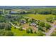 Stunning aerial shot of the property nestled in a serene, green landscape with mature trees and open fields at 303 Crooked Meadow Ln, Hillsborough, NC 27278