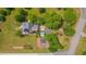 Aerial view of the home showing a garden, solar panels, trees, and a convenient storage shed at 303 Crooked Meadow Ln, Hillsborough, NC 27278