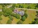 Scenic aerial view of the house surrounded by verdant trees and well-maintained grassy yard at 303 Crooked Meadow Ln, Hillsborough, NC 27278