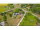 Aerial view of home with solar panels surrounded by green fields and a mix of trees and shrubs at 303 Crooked Meadow Ln, Hillsborough, NC 27278
