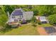 Aerial view of home with solar panels featuring a deck and a red outbuilding at 303 Crooked Meadow Ln, Hillsborough, NC 27278
