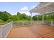 Back deck features a white pergola, a white railing and wood flooring at 303 Crooked Meadow Ln, Hillsborough, NC 27278