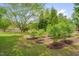 Lush green backyard featuring beautiful mature trees and landscaping around the perimeter at 303 Crooked Meadow Ln, Hillsborough, NC 27278