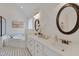 Bright bathroom with dual sinks, quartz countertops, and decorative mirrors at 303 Crooked Meadow Ln, Hillsborough, NC 27278