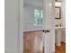 Bright bathroom features a pedestal sink, classic fixtures, and a view to the adjacent room with ample natural light at 303 Crooked Meadow Ln, Hillsborough, NC 27278