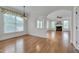 Sunny dining area with connecting archway into the living room with fireplace at 303 Crooked Meadow Ln, Hillsborough, NC 27278