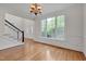 Dining room with hardwood floors, chandelier, and large windows offering natural light at 303 Crooked Meadow Ln, Hillsborough, NC 27278