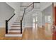 Bright foyer with hardwood floors, staircase, and views into adjacent rooms at 303 Crooked Meadow Ln, Hillsborough, NC 27278